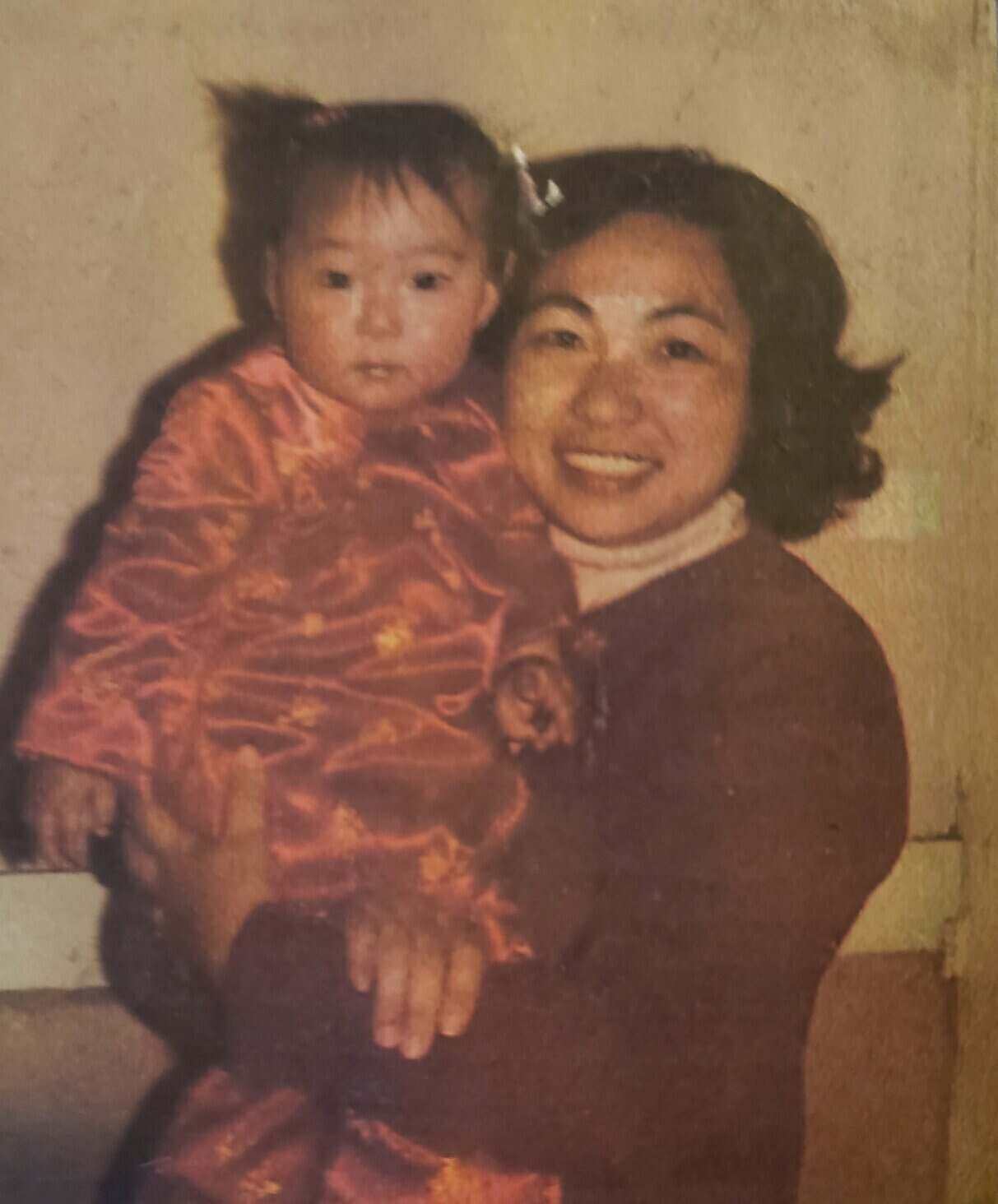 young nancy chang being held by her mom
