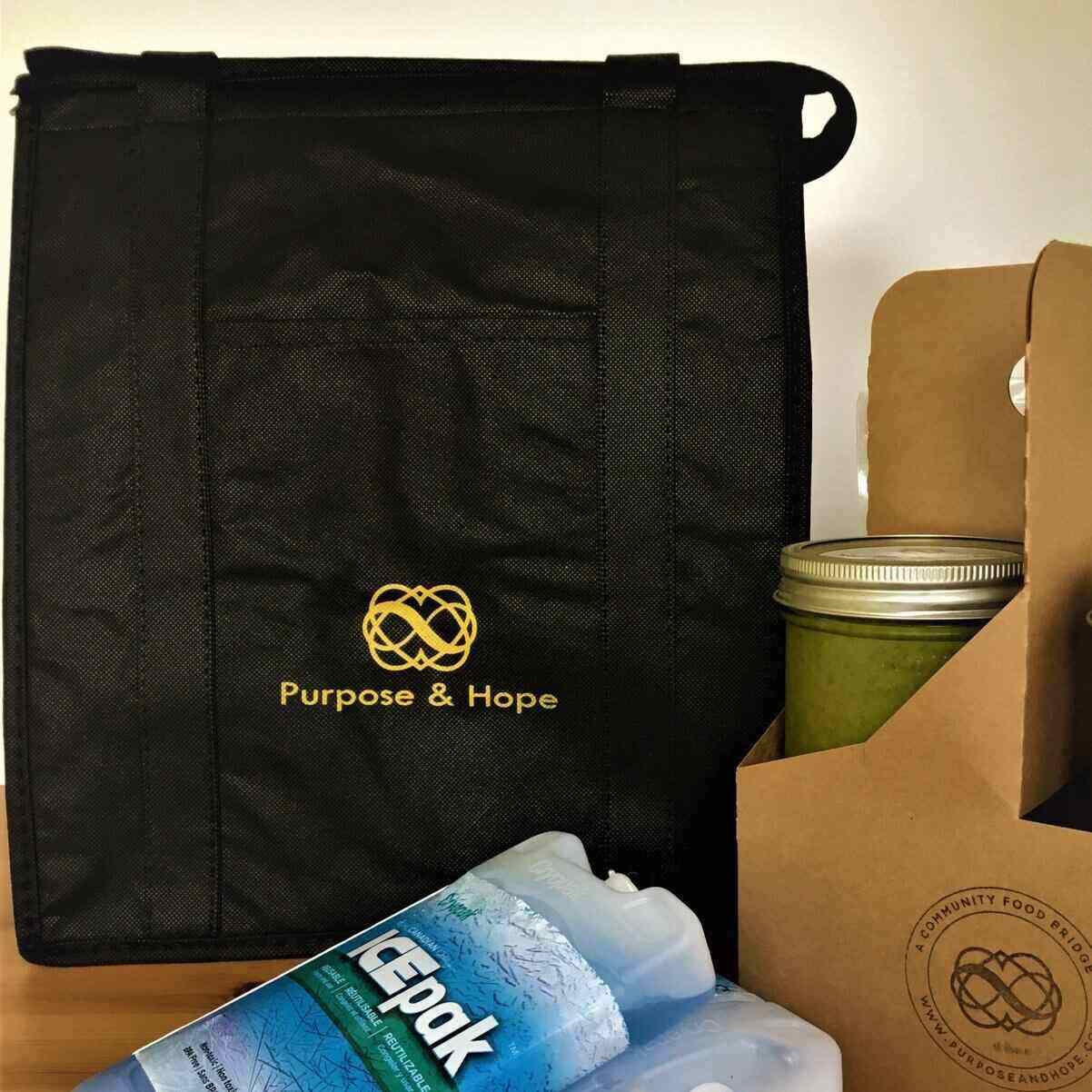 Purpose & Hope tote bag with logo behind ice packs and green soup jar.